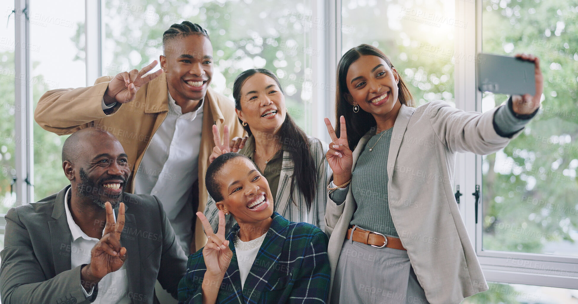 Buy stock photo Employees, selfie and smile with peace sign at office for profile photo with diversity or marketing team. Happy, face, worker and hand gesture for collaboration and cellphone for social media update.