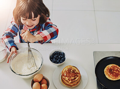 Buy stock photo Boy, baking and above in happy kitchen, ingredients and mixing bowl or pancake batter in morning apartment. Culinary skills, kid and mixture or cooking breakfast, child development and healthy recipe