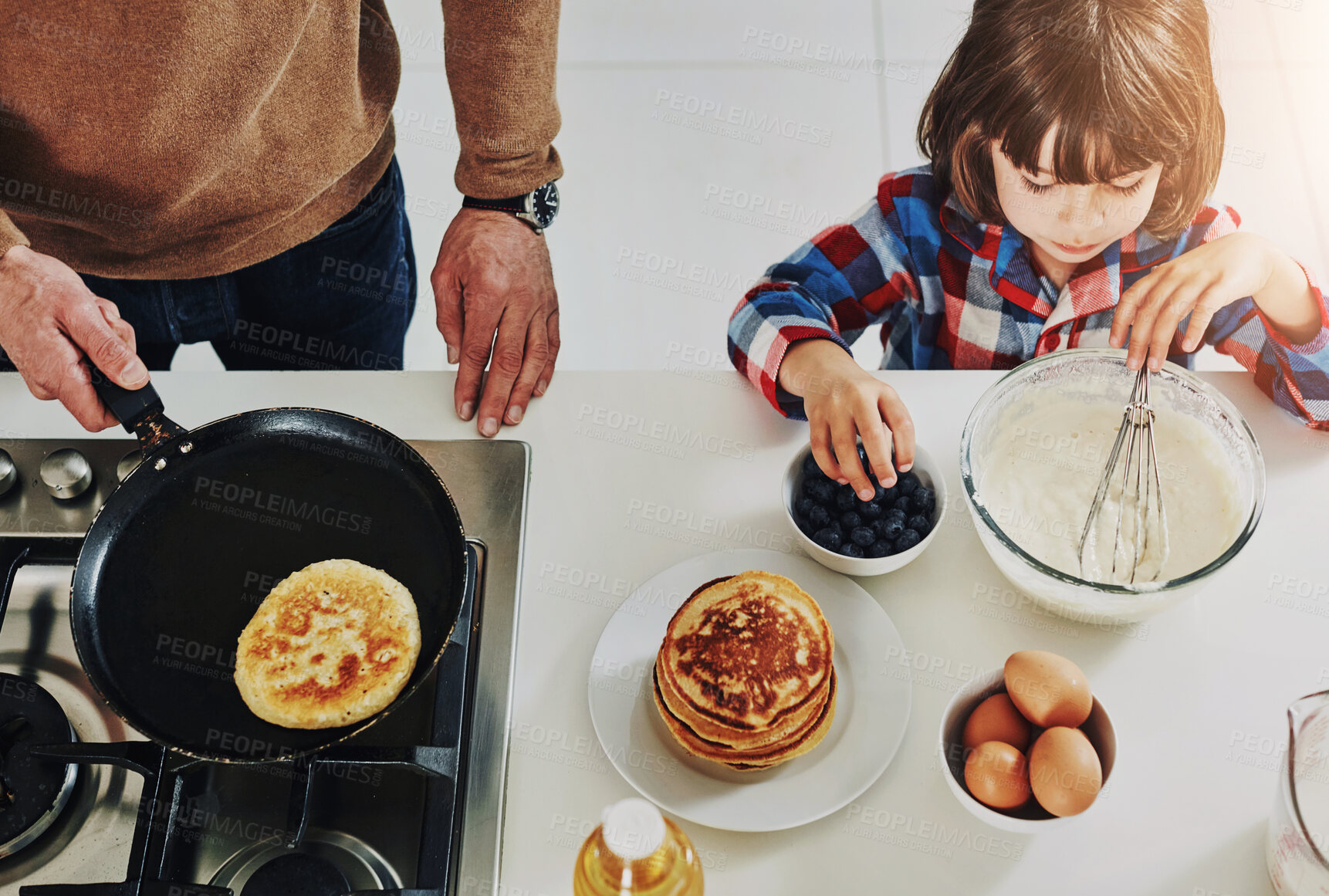 Buy stock photo Hands, father and boy with pancakes, baking and bonding together with hobby, ingredients and teaching. Above, single parent and kid with dad, healthy food and breakfast with break, home and help