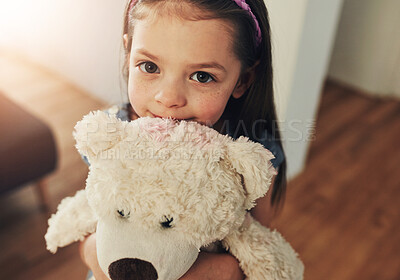 Buy stock photo Portrait, home and girl with teddy bear, hug and playful with happiness, cheerful and relax in lounge. Face, kid and childhood with stuffed animal and embrace for fun, break and emotional support toy