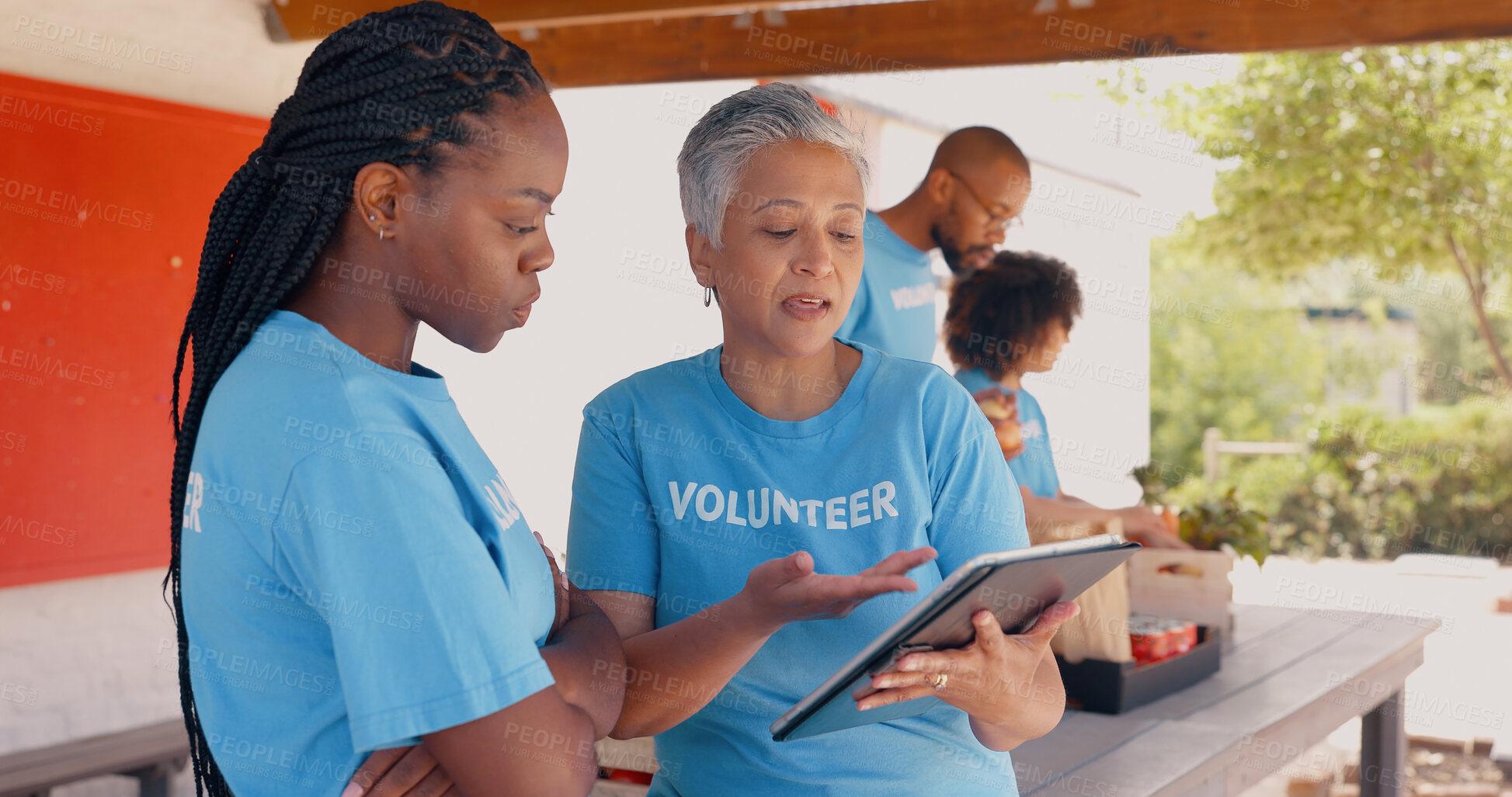 Buy stock photo Teamwork, volunteer and women on tablet for charity discussion, meeting and planning. Volunteering, collaboration and people in digital tech talking for donation, ngo business and community service