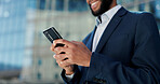 Businessman, hands and typing with phone in city for communication, social media or outdoor networking. Closeup of man or employee smile with mobile smartphone for online chatting or texting in town