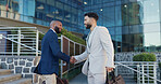 Businessman, handshake and meeting with colleague in city by steps outside building for greeting or introduction. Business people walking and shaking hands with employee for partnership or welcome
