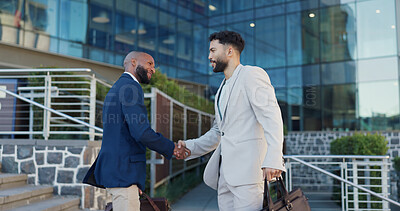Businessman, handshake and meeting with colleague in city by steps outside building for greeting or introduction. Business people walking and shaking hands with employee for partnership or welcome