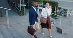 Business man, woman and talking in street on commute to work in metro with discussion, chat and walking. People, staff and employees with bag, outdoor and conversation for travel on metro sidewalk