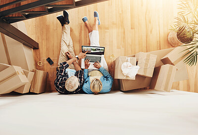 Buy stock photo High angle shot of a mature couple using a laptop together on moving day