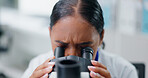 Woman, microscope and scientist with analysis of data, science experiment or medical research in laboratory. Assessment, test or review DNA sample with biotechnology or biology, innovation and future