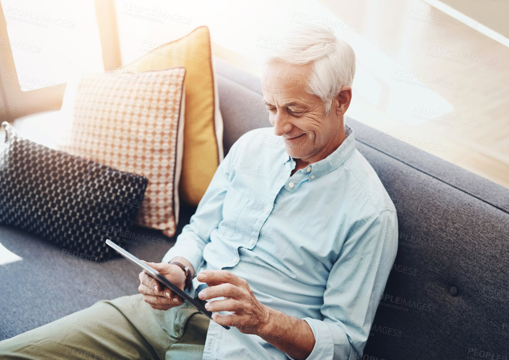 Buy stock photo Senior man, tablet and relax on sofa in home for typing email, communication and reading online news. Elderly person, technology and retirement in lounge for bills payment, webinar and writing ebook