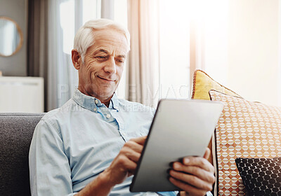 Buy stock photo Senior man, technology and relax on sofa in home for typing email, communication and reading online news. Elderly person, tablet and retirement in lounge for bills payment, webinar and writing ebook