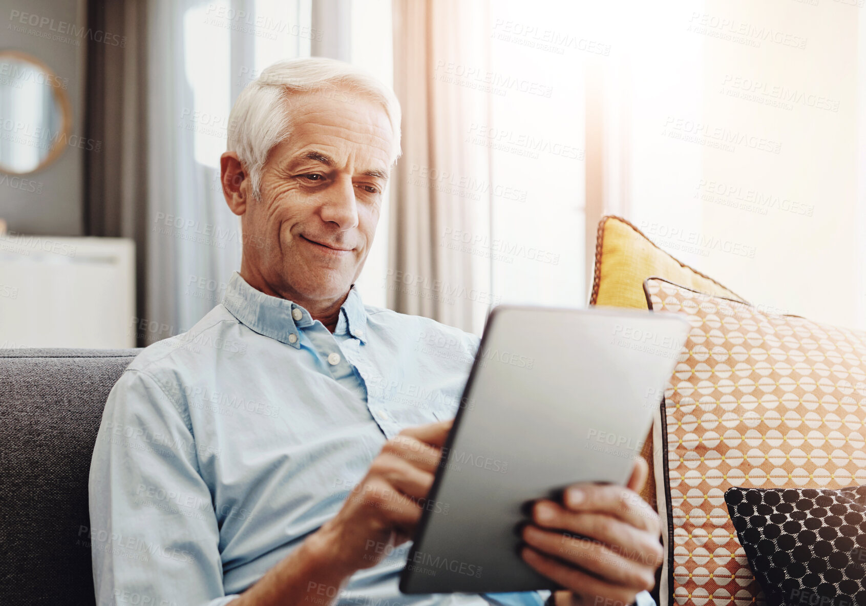 Buy stock photo Senior man, technology and relax on sofa in home for typing email, communication and reading online news. Elderly person, tablet and retirement in lounge for bills payment, webinar and writing ebook