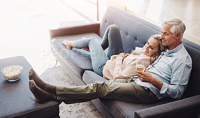 Buy stock photo Watching tv, home and mature couple with movie, series and film streaming with love and support. News, smile and bonding of happy people together on a living room sofa with food, drink and hug