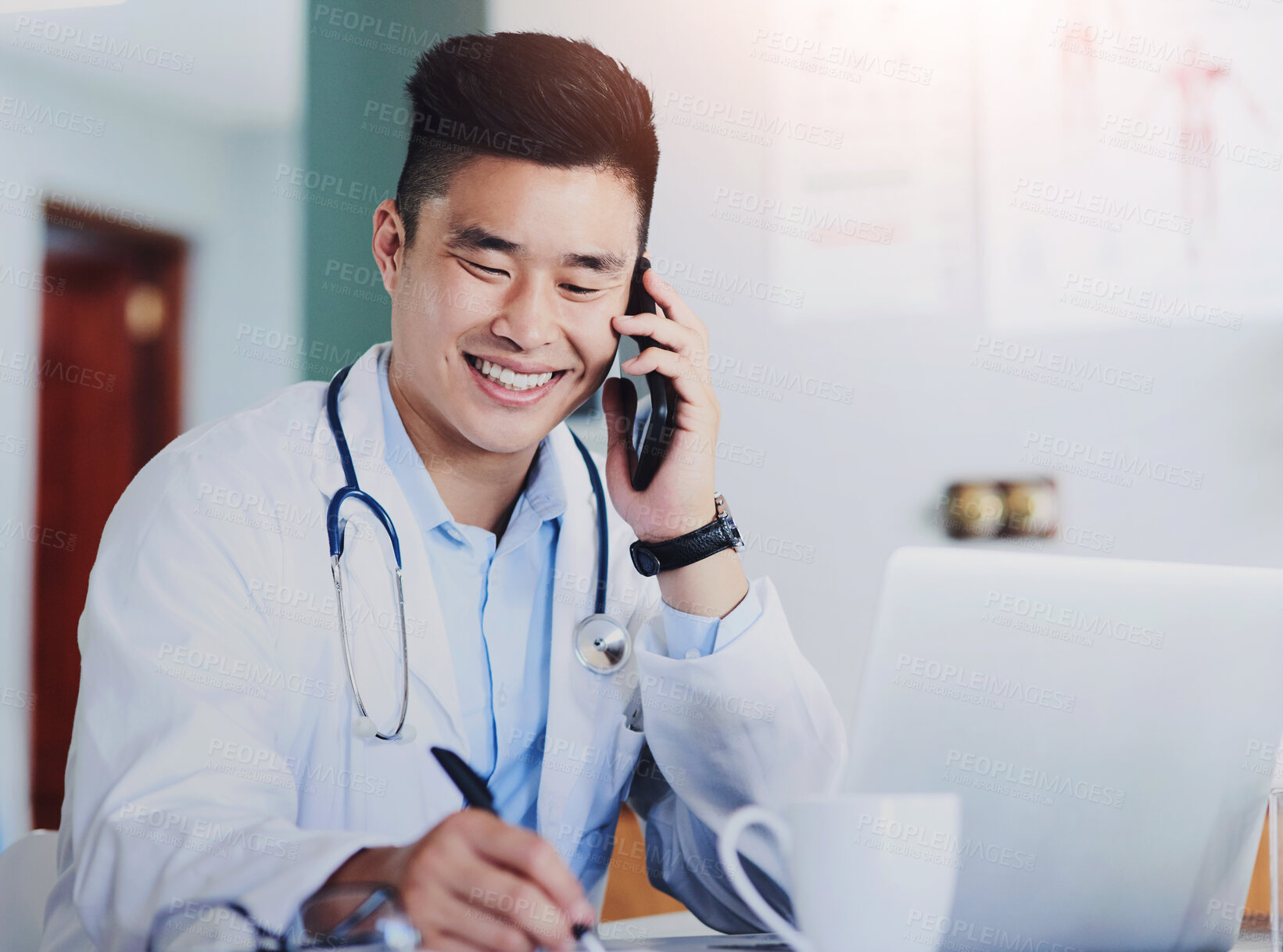 Buy stock photo Healthcare, laptop and phone call with doctor writing in office of hospital for appointment or schedule. Computer, notepad and smile with asian medicine professional in clinic for consultation