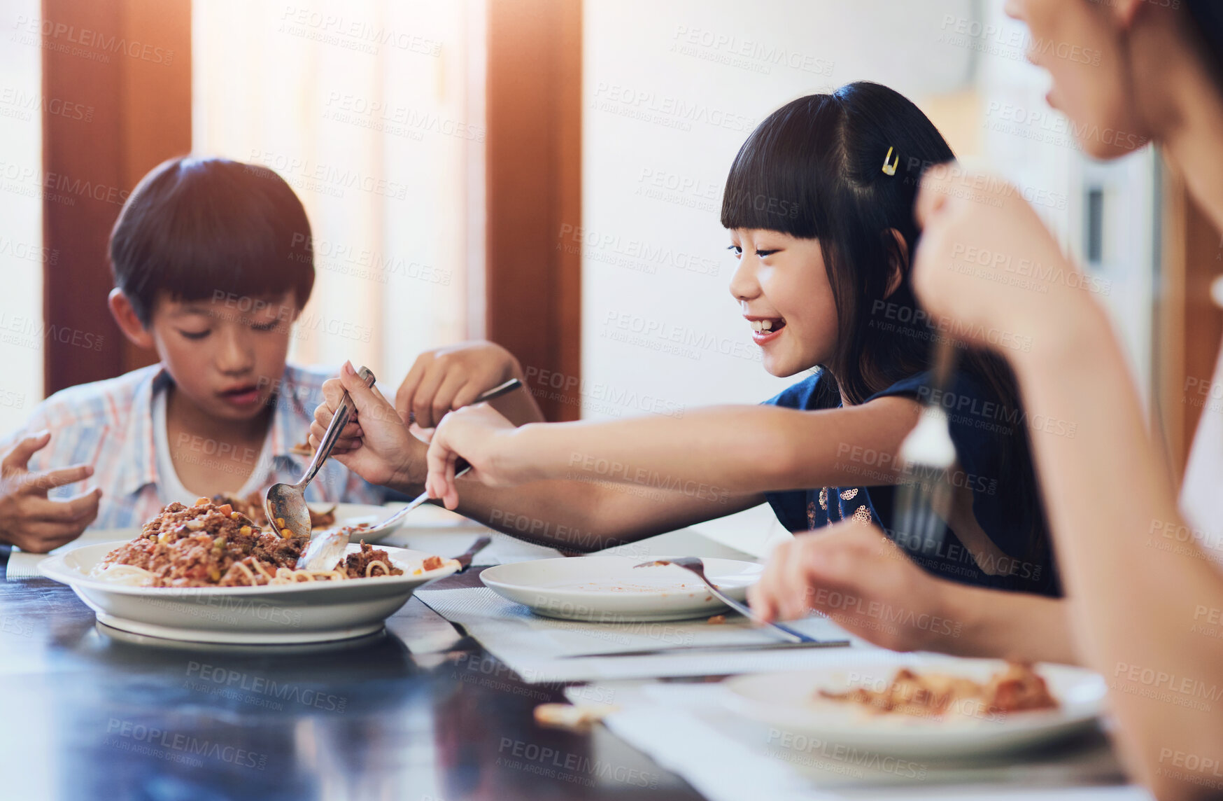 Buy stock photo Asian family, food and children eating in dining room for nutrition, dinner or spaghetti. Hunger, wellness and happy kids with mom at table for healthy meal, noodles or growth development in home