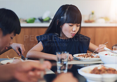 Buy stock photo Shot of two little children enjoying a meal with their mother at home