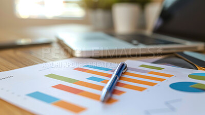 Graphs, paper and pen on desk for analysis, information and market research with financial statistics. Analytics, economics and accounting with profit, assets and stocks for investment with report