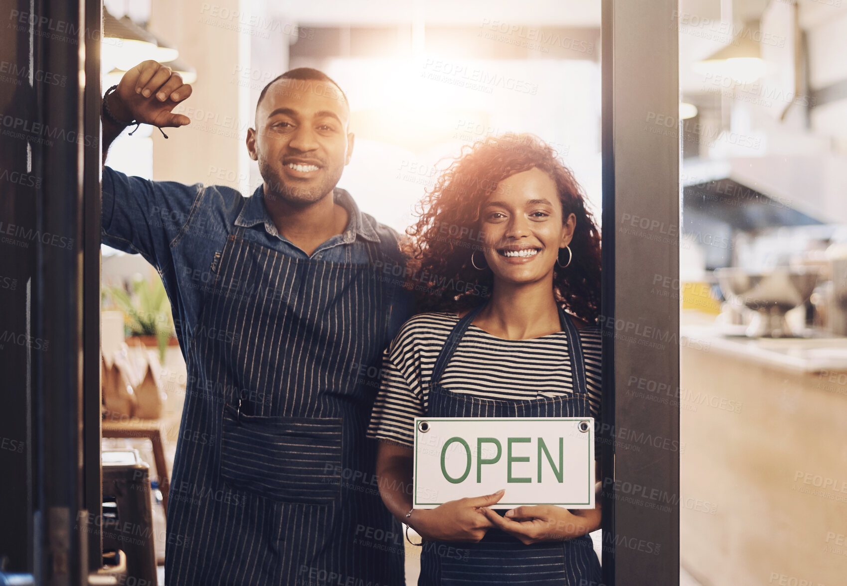 Buy stock photo Coffee shop, open sign and portrait of people in cafe for small business, teamwork and collaboration. Restaurant, hospitality and happy man and woman by cafeteria door for service, help and welcome