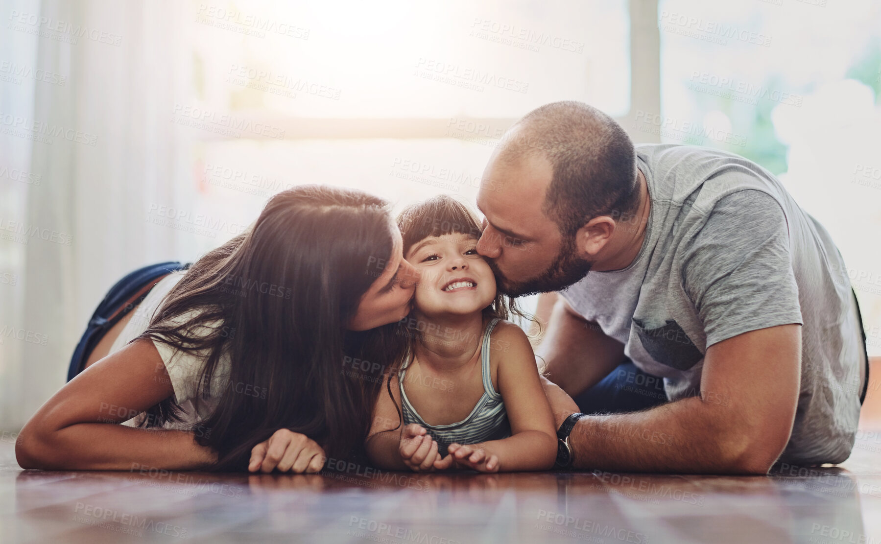 Buy stock photo Portrait of a mother and father bonding with their adorable young daughter at home