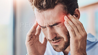 Buy stock photo Shot of a uncomfortable looking man holding his head in discomfort due to pain at home during the day