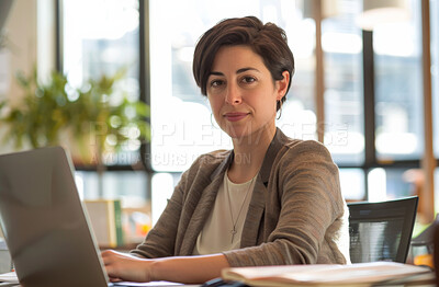 Serious, woman and laptop in office for online work in creative company, typing or proofreading article for editing. Girl, digital technology and reading essay for content review and checking grammar