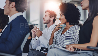 Buy stock photo Low angle shot of a group of businesspeople sitting in the conference room during a seminar