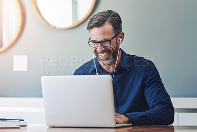 Buy stock photo Shot of a cheerful middle aged businessman making a Skype call on his laptop at home during the day