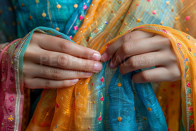 Clothes, culture and hands of Indian woman in colorful outfit closeup for belief, faith or religion. Bollywood, fashion and getting ready with person dressing in clothing for heritage or tradition