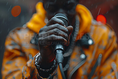 Black man, rap and hand with mic in performance for event, entertainment or outdoor music festival. Artist, singer and musician with equipment at live concert for hip hop, show or function in Chicago