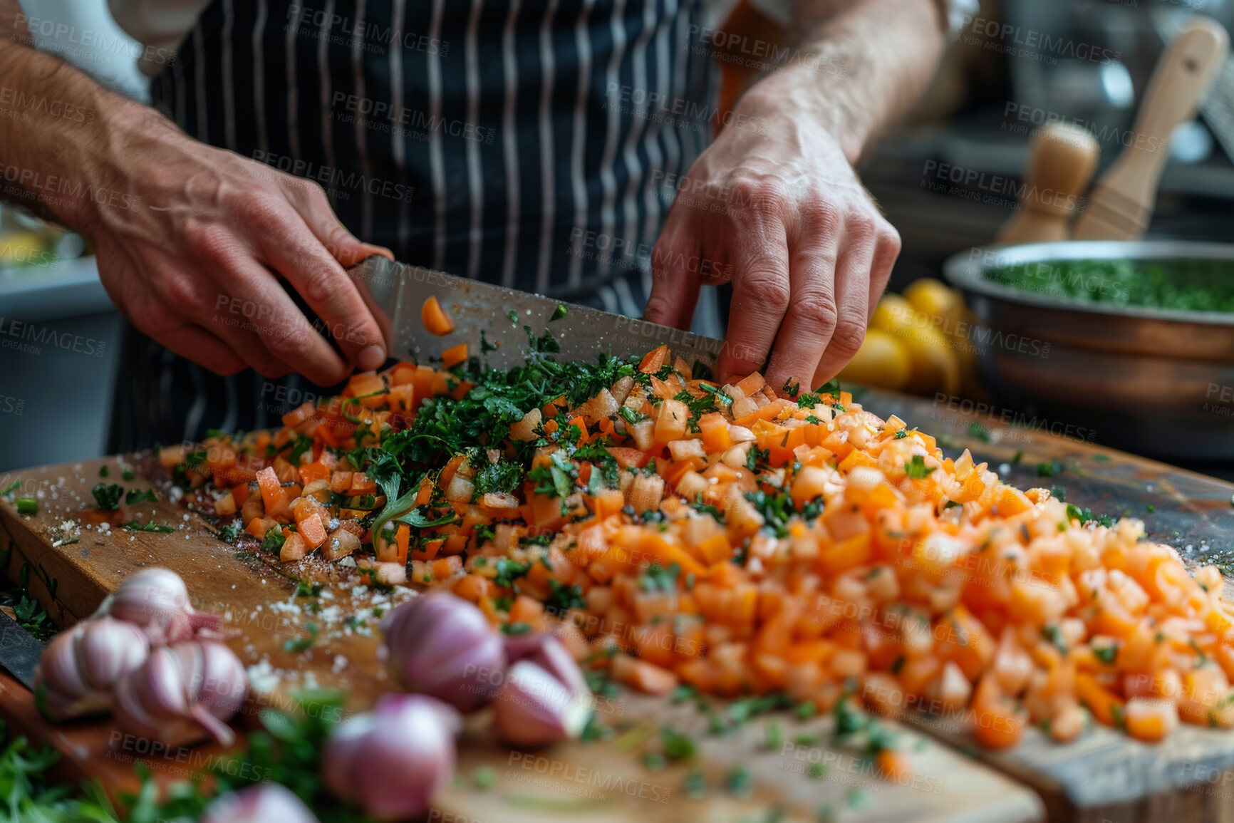 Buy stock photo Person, cooking and hands with vegetables or knife for preparing chop tomato with garlic, healthy or dinner. Chef, career and wooden board in kitchen with apron for professional meal, brunch or diet