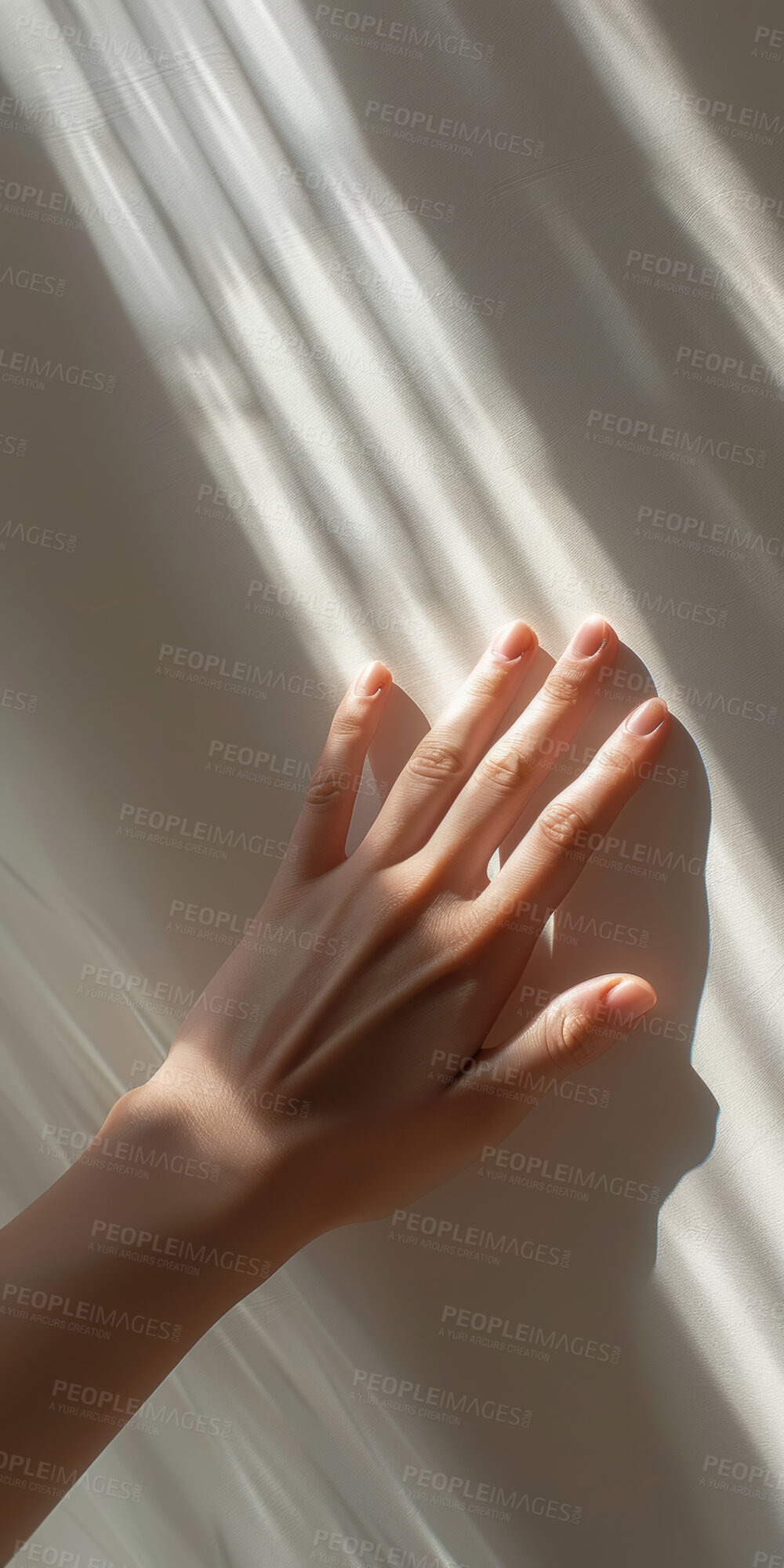 Buy stock photo Hand, light and person touching wall for sense of feel, texture or warmth closeup in studio. Fingers, shadow and sun with adult rubbing smooth surface for consistency, grain or quality in summer