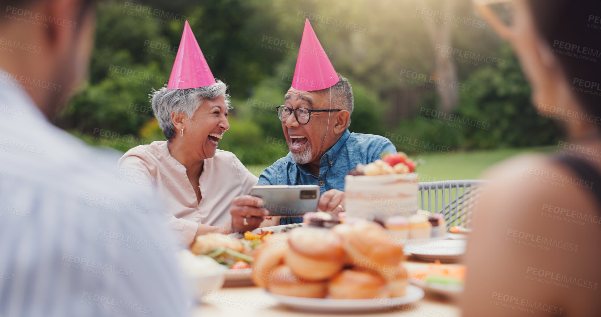 Buy stock photo Senior, family and happy with video call at birthday party for celebration, laughing and memories in garden. Elderly, man and woman with smartphone for photography, gathering and event in home