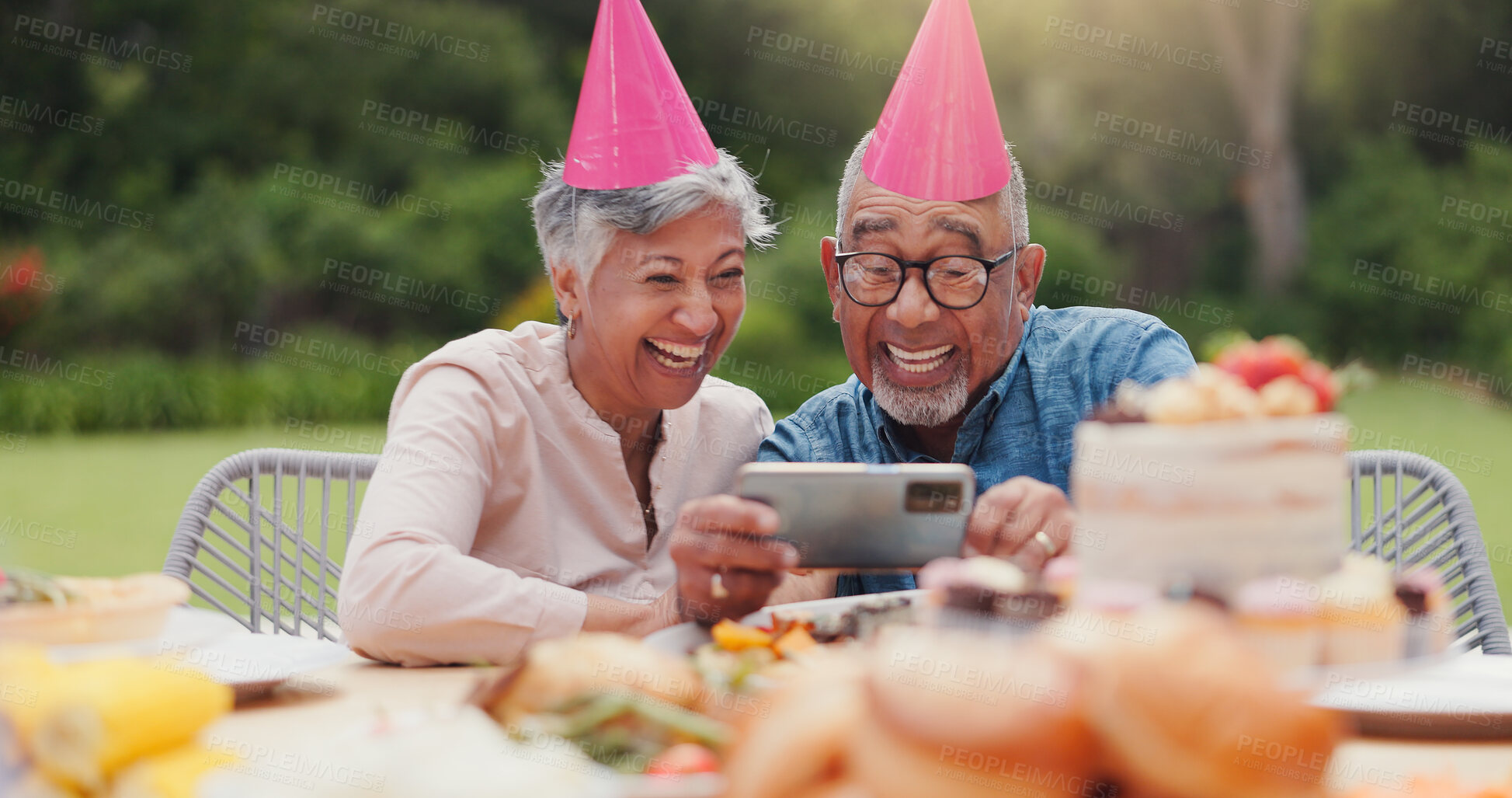 Buy stock photo Elderly, couple and happy with video call at birthday party for celebration, laughing and memories in garden. Senior, man and woman with smartphone for photography, gathering and event in home