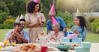 Family, clapping hands and happy with hat at birthday party for celebration, surprise or sparkler in garden of home. Grandparents, parents and kids with applause for gathering and event in backyard