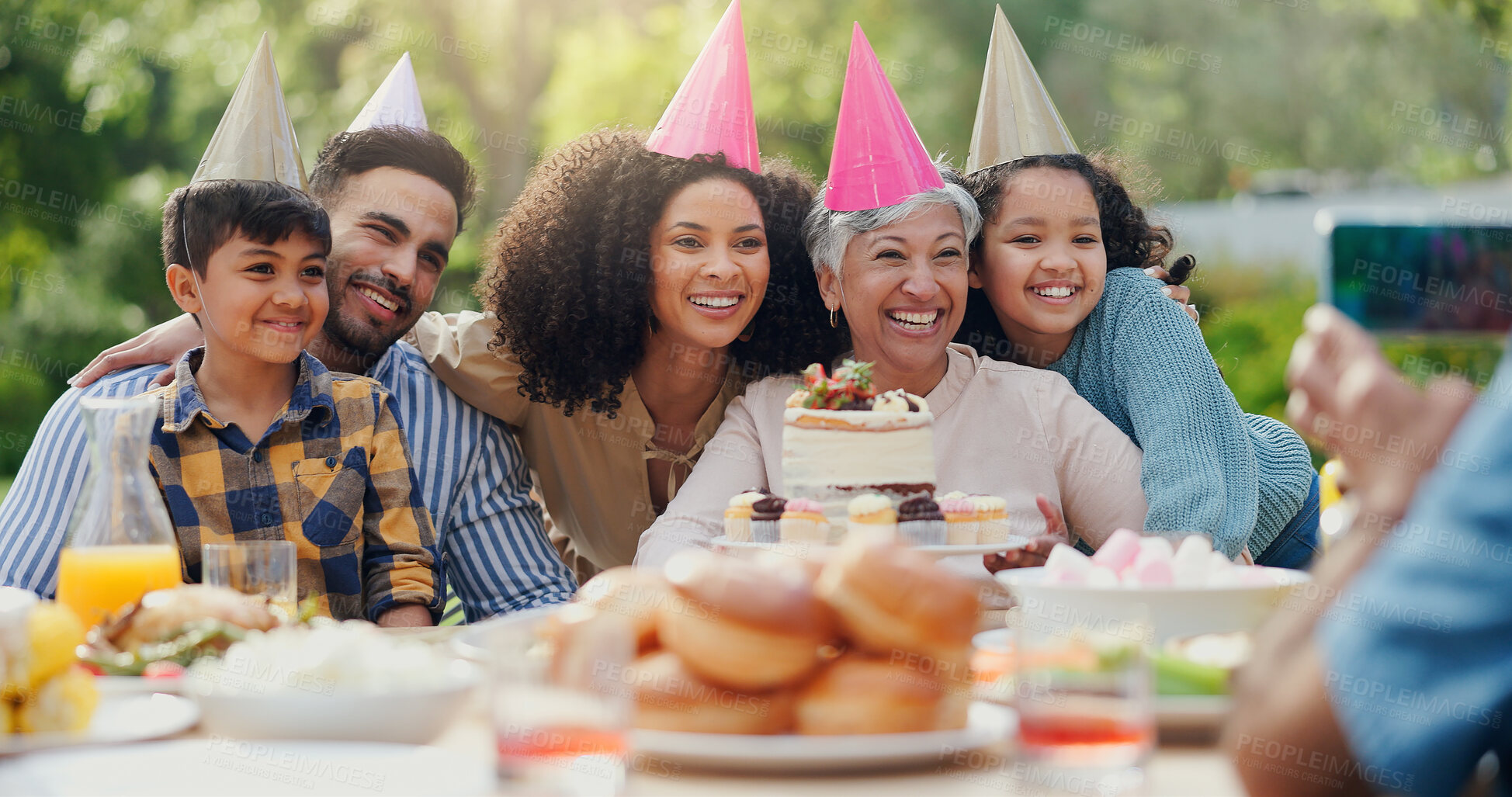 Buy stock photo Big family, photography and birthday party for happy outdoor celebration and online memory with cake. Parents, grandmother and kids in backyard for social event in garden and festive hat with dessert