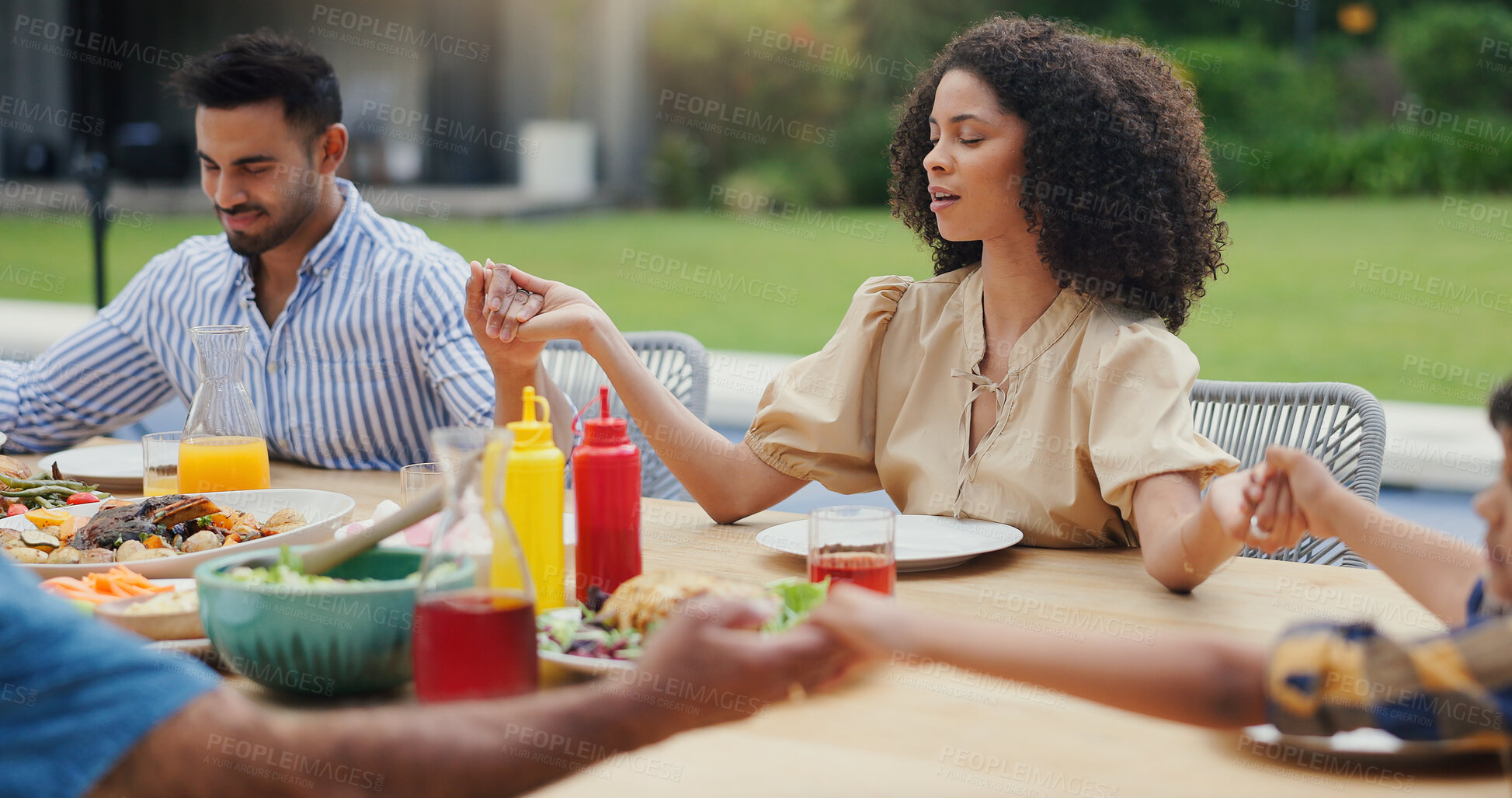 Buy stock photo Holding hands, prayer and food with gratitude at party, people worship and outdoor at social gathering. God, wellness and faith, nutrition and eating at birthday with support and care at celebration