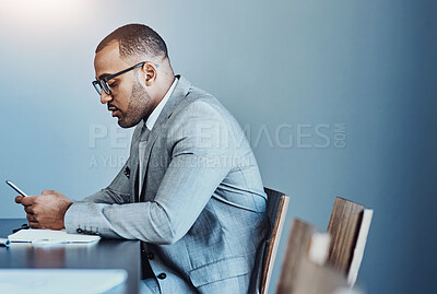 Buy stock photo Businessman, boardroom and typing with phone for communication, schedule or finance at office. Young man, accountant or employee on mobile smartphone for business proposal, tasks or news at workplace