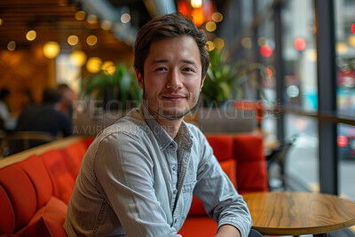 Portrait, smile and asian man in restaurant, relaxing and weekend break with casual clothes, dining and calm. Face, Korean person and guy in cafe, sitting on couch and peaceful with happiness and joy