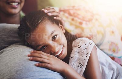 Buy stock photo Portrait of an adorable little girl resting on her mother's pregnant stomach at home