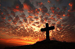 Outdoor, sunset and cross for religion, sky and spiritual with clouds, silhouette and symbol for forgiveness. Compassion, worship and countryside with Christian icon, resurrection and holy with faith