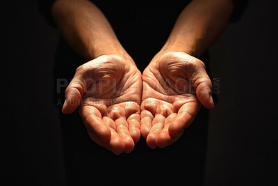 Buy stock photo Person, hands and praying with faith for god, religion or submission on a dark studio background. Closeup of prayer with light on palms together for hope, charity or care in support, peace or offer