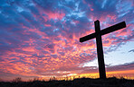 Clouds, sunset and cross for religion, Christianity and spiritual with silhouette and icon for forgiveness. Compassion, worship and countryside with symbol for resurrection and spiritual with faith