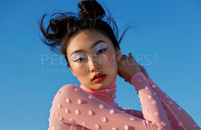 Blue background, portrait and asian girl with eyeshadow for beauty, makeup and cosmetics in studio. Creativity, face aesthetic and female person with confidence, advertising and glamour by mockup