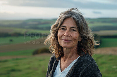 Portrait, nature and mature woman in mountains, travel and holiday or walk or trekking. Face, smile and hills in countryside of Switzerland for female person, adventure and vacation fitness or hiker