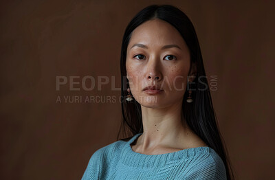 Serious, business and portrait of Asian woman in studio for career, pride and confidence in job. Journalist, female person and face of reporter for production, hosting and media on brown background