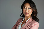 Asian woman, portrait and confident employee in studio, serious lawyer and pride on gray background. Female person, entrepreneur and mockup space for professional, attorney and career opportunity