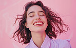 Girl, happy and smile with eyes closed by pink background for good news, memory and makeup in studio. Female person, face and cheerful with nostalgia or idea for skincare, cosmetics or routine