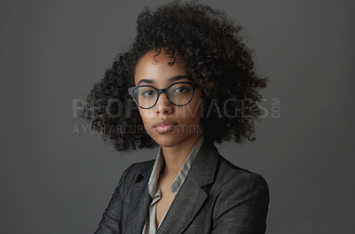 Portrait, professional and black woman lawyer in glasses on studio gray background for court case. Confident, mission and suit with serious attorney in trial for council, law or legal representation