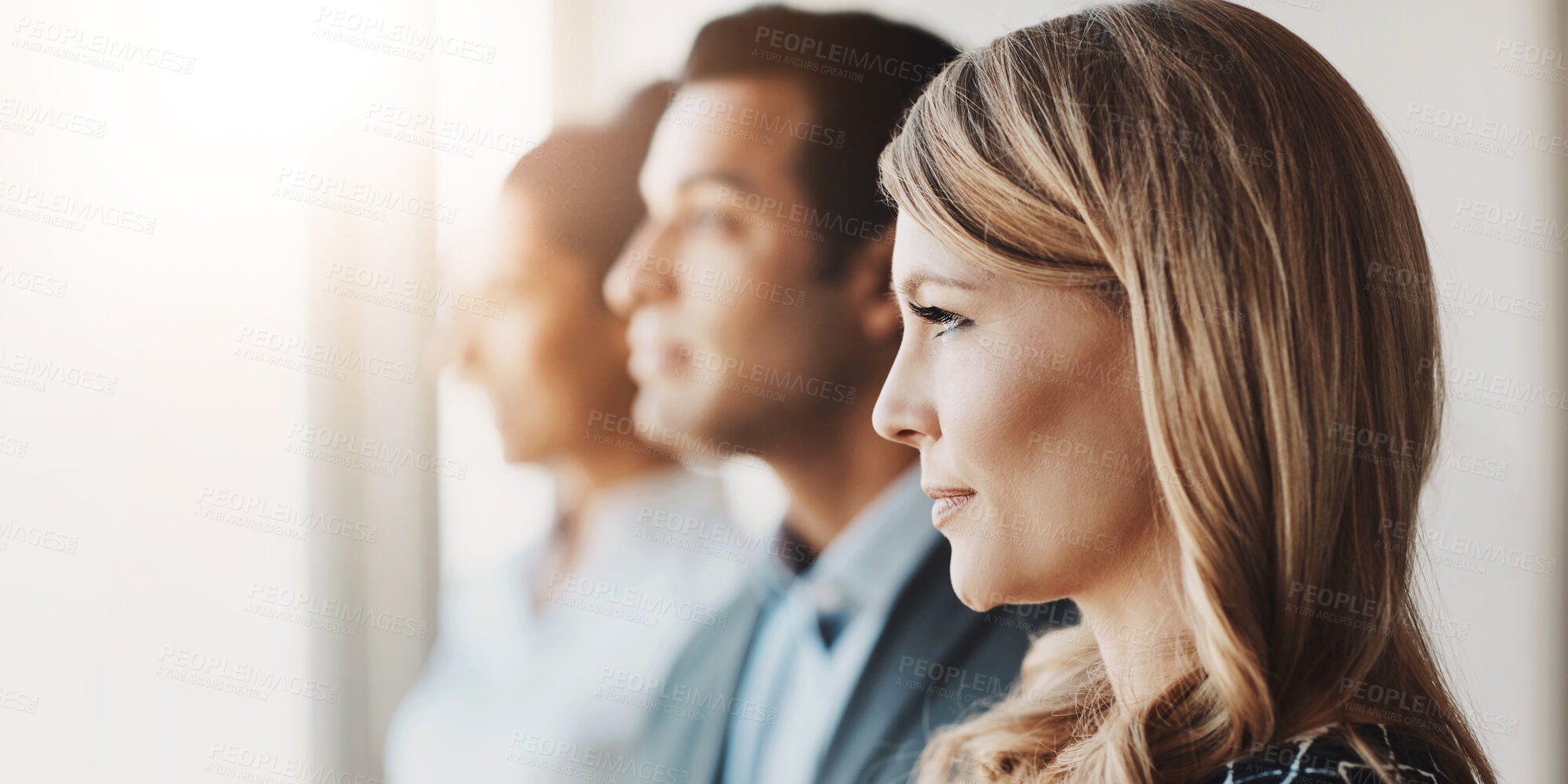 Buy stock photo Shot of a young businesswoman standing in an office with her colleagues in the background