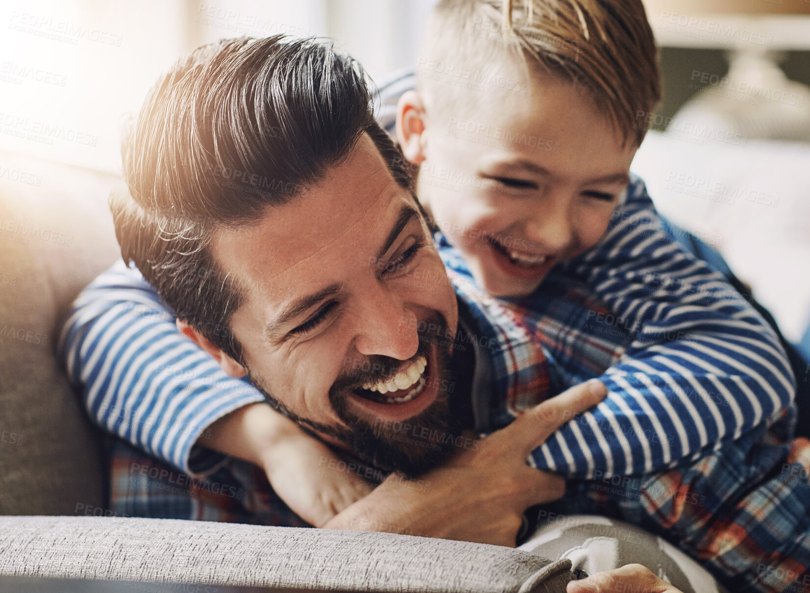 Buy stock photo Father, child and hug in house for bonding with family, learning and development for youth wellness. Dad, son and happiness in home with love and care relationship, embrace on sofa for healthy relax