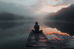 Person, pier and lake with mindfulness meditation at sunset for spiritual zen or yoga wellness, morning or peace. Silhouette, healing and relax chakra at holistic resort with river, forest or mist