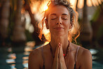 Travel, calm and woman with meditation on vacation at luxury resort with pool at sunset for zen. Peace, spiritual and female person praying for relax, gratitude or balance on holiday or weekend trip.